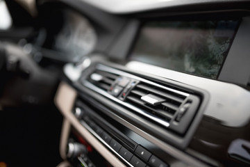 Fototapeta na wymiar modern car interior with close-up of ventilation system holes