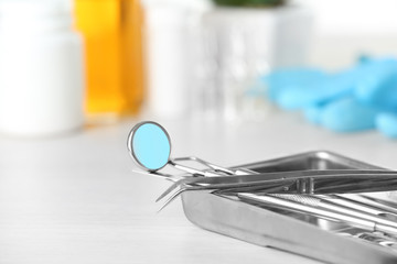 Dentist tools in metal tray on table close up