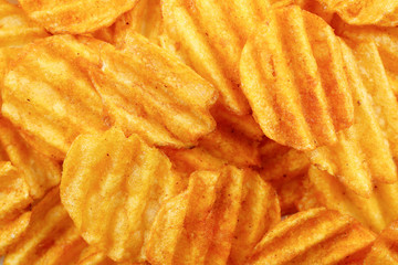 Delicious potato chips closeup background