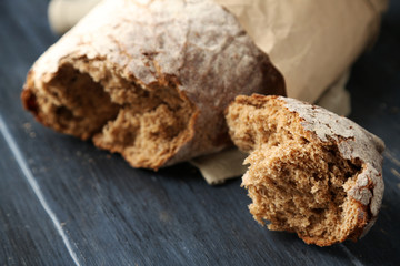 Fresh  baguette on wooden table, close up