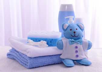 Baby accessories for bathing on table on light background