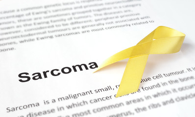 Paper with sarcoma   and yellow ribbon.