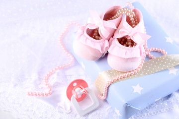Pink baby boots with gift close-up