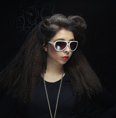 brunette wearing sunglasses posing in the studio
