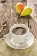 coffee cup black wooden board brown pears white