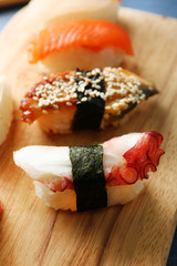 Sushi on board on wooden table background