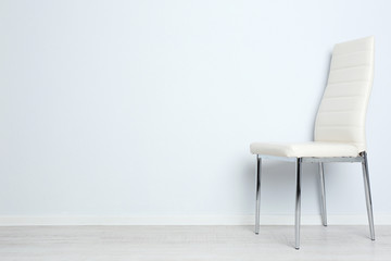 Modern chair on white wall background