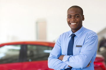 african american car sales consultant with arms folded