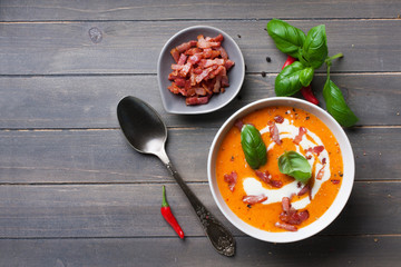 Carrot sweet pepper cream soup with bacon