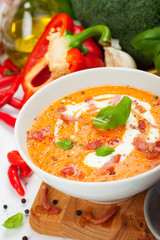 Carrot sweet pepper cream soup with bacon