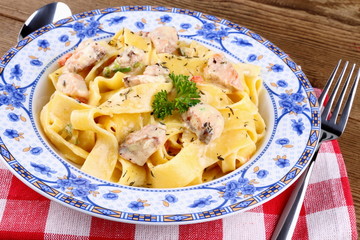 Piece of salmon fillet with tagliatelle, cream sauce