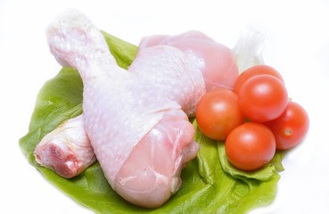 Fresh chicken thighs on white background and tomatoes