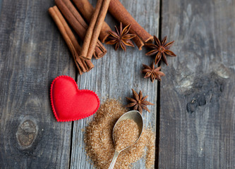 cinnamon sticks and anise stars on rustic wooden background