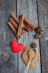 cinnamon sticks and anise stars on rustic wooden background