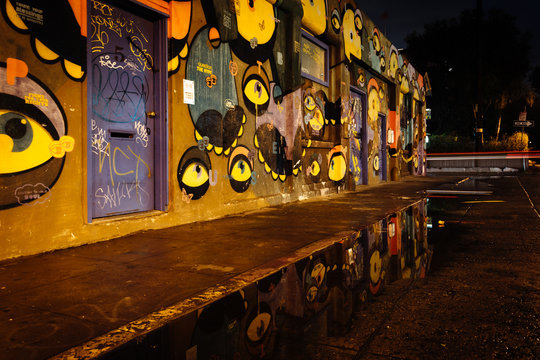 Street Art Reflecting In A Puddle At Night, In Venice Beach, Los