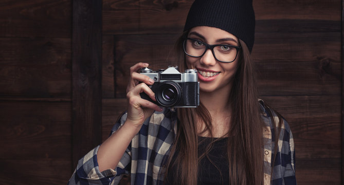 girl in glasses and braces with vintage camera