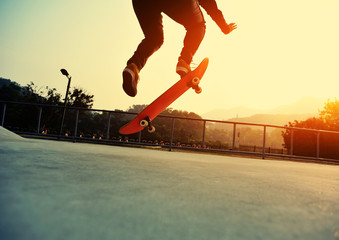 skateboarder jumping on sunrise skatepark
