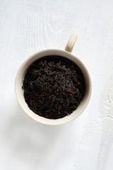 Black tea leaves on a white table