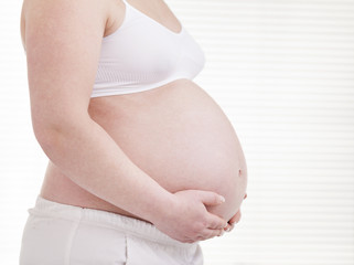 Pregant woman holding his belly