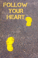 Yellow footsteps on sidewalk towards Follow your heart message