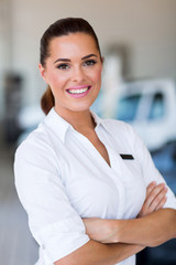 saleswoman standing at car dealership