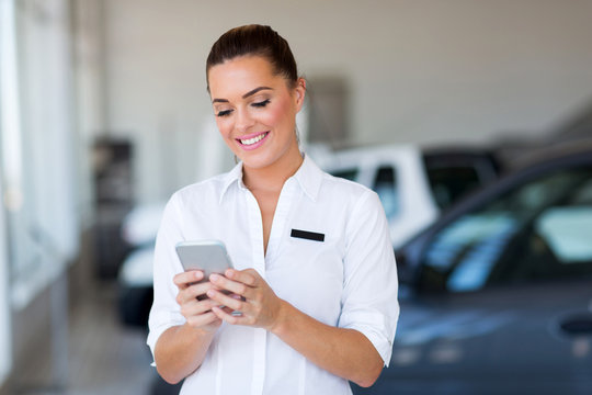 Young Car Sales Consultant Using Smart Phone