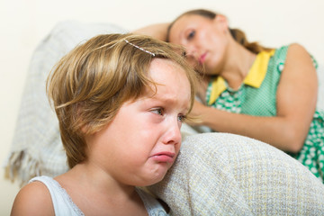 Obraz na płótnie Canvas Crying child and mother having quarrel