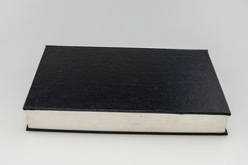 Blank  black hardcover book isolated on white background with co
