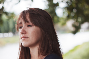 Girl cries. Puffy eyes. Emotional portrait of beautiful brunette. Depression, sadness, loneliness
