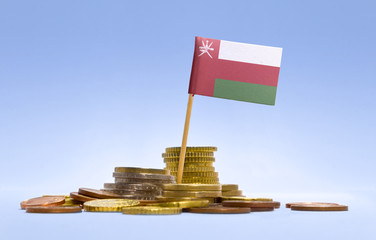 Flag of Oman in a stack of coins.(series)