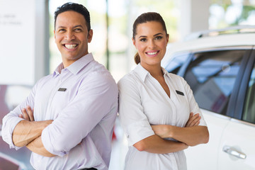 sales staff standing in vehicle showroom