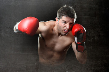 Fototapeta na wymiar furious man training boxing on gym throwing vicious punch