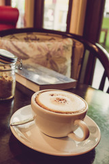 Coffee cup on the wooden table.