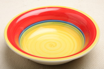 Empty red and yellow plate.