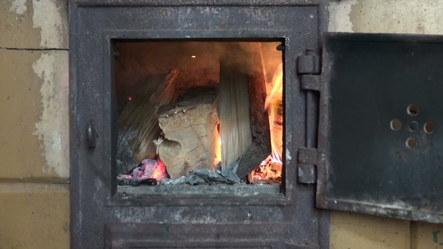 fire flame and smoke in old fireplace in farm
