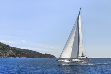 Fototapeta na wymiar Sailing in the wind through the waves. Yachting.