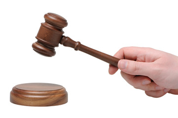 Hand with gavel on a white background