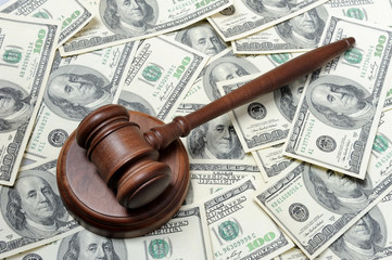 Gavel with support on dollars