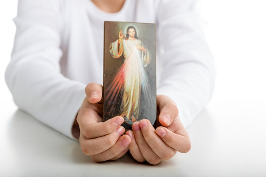 Caucasian boy showing  Merciful Jesus icon