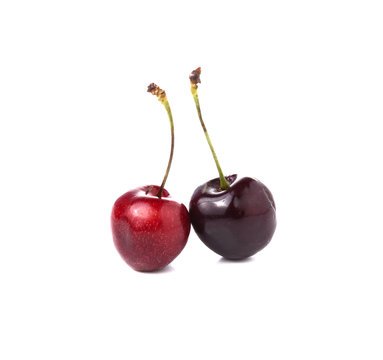 Two cherries on white background, black and red cherries on whit