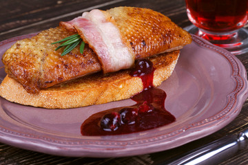 Roasted duck breast fillet with bacon and black currant sauce