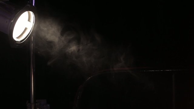 sinle spot light stage lightning with dust particles in front