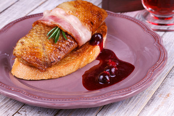 Roasted duck breast fillet with bacon and black currant sauce
