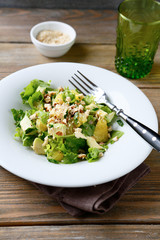 Salad with Avocado, Lettuce, Orange and Nuts on a bowl