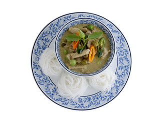 Thai green curry pork and rice noodles served on dish with white