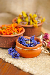 Fototapeta na wymiar Healing herbs on sackcloth, dried flowers, herbal medicine