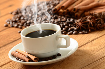 Coffee cup with smoke and coffee beans around