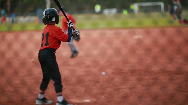 Cool shot of a Kid Batting at a Baseball Game