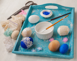 Easter eggs decorated with lace on a tray