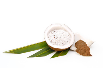 Coconut and grounded coconut flakes isolated on white background